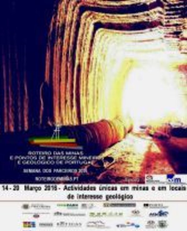 Imagem de uma mina iluminada, com paredes de rocha e um túnel que se estreita.