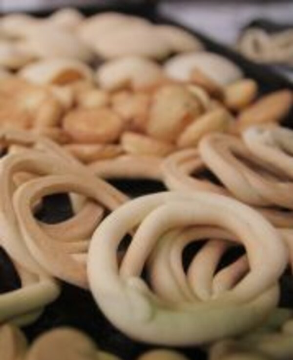 Diversos biscoitos em forma de laço, com diferentes texturas e cores.