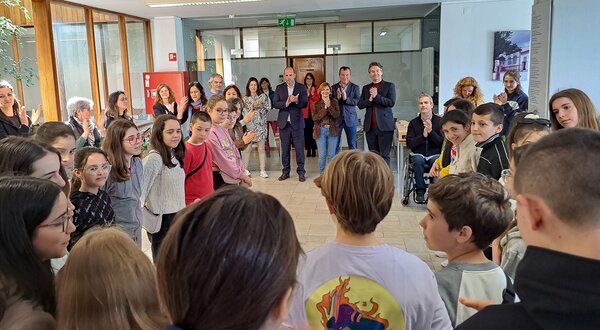 Grupo de crianças e adultos reunidos num ambiente de celebração.