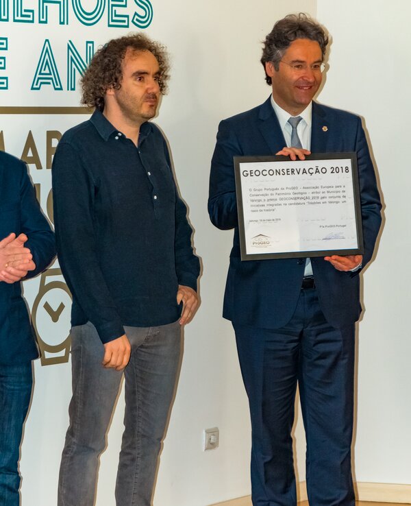 Duas pessoas a receber um prémio de Geoconservação 2018, com um diploma.