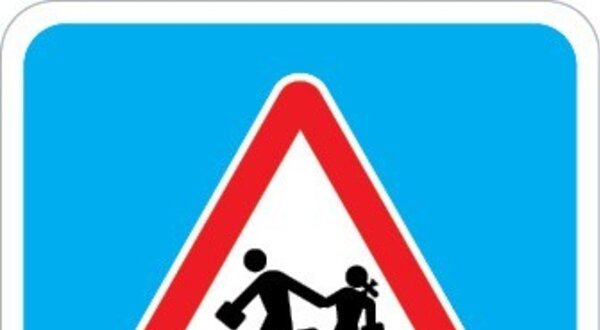 Sinal de aviso com figuras de adultos e crianças a caminhar, alerta para escolas.